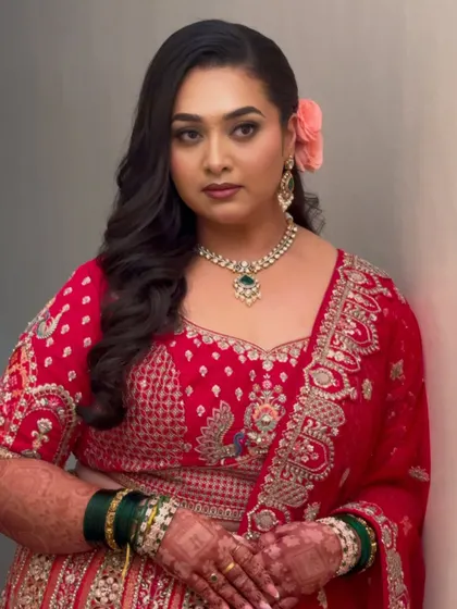 A vintage-inspired reception look for my beautiful bride. The bold red lehenga is paired with classic Hollywood waves and a soft glam makeup look.