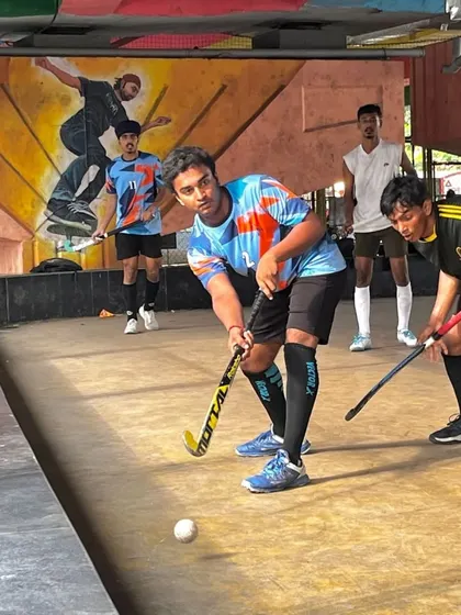 A player prepares to take a shot during a practice game. The graffiti art in the background captures the urban energy of our unique Sanpada training ground under the flyover.