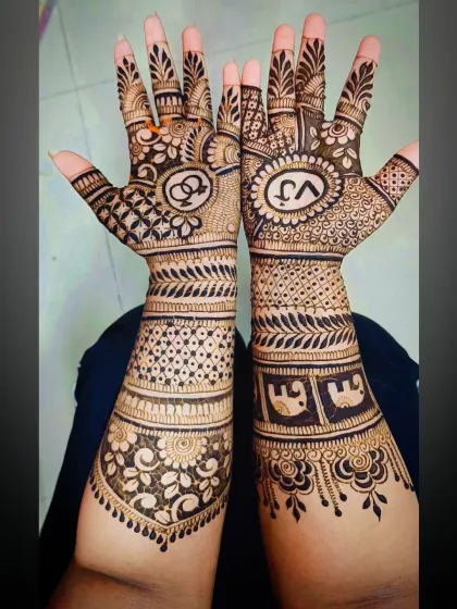 A clear view of the elephant motifs on the forearm, combined with personalized initials and interlocking rings for a complete story.