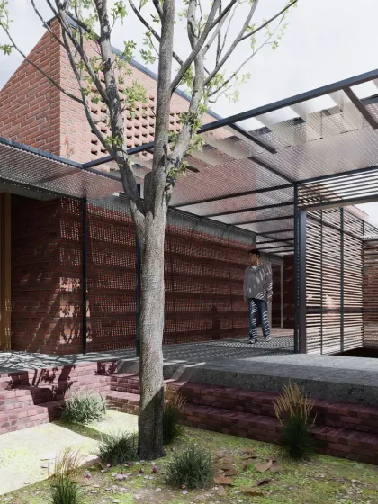 A courtyard at Studio Tarai, where a tree grows through an opening in the structure. The design uses layers of brick, steel, and slatted screens to create a rich texture and a seamless flow between built and unbuilt spaces.