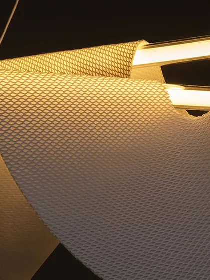 A macro shot of the Drape Light's textured, fabric-like material, which is specially designed to be rigid yet appear soft and flowing.
