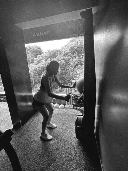 A client uses the SkiErg machine, captured in a gritty black and white photo that highlights the intensity of the workout.