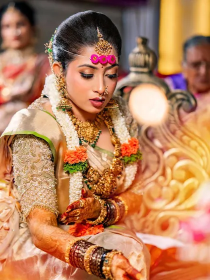 A beautiful moment of prayer. The bride's gold saree and custom blouse create a look of divine elegance.