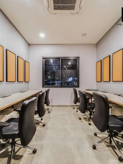 This is the open-plan workspace within the Embassy marketing office, featuring rows of desks and acoustic panels. The design prioritizes a clean, organized, and productive environment for the sales team.