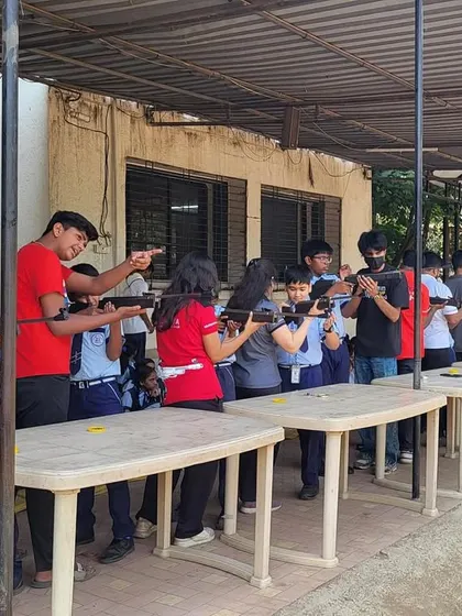 My coaches providing one-on-one guidance to students during a school workshop. This personal attention helps demystify the sport and builds confidence in young, first-time shooters.