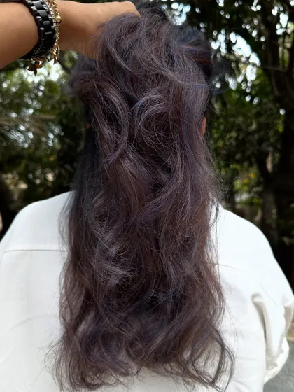 Holding up a section to show the blend of the purple and natural dark tones.