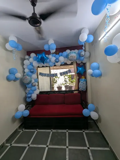 A wider view of the blue-themed welcome baby decor, showing how even a simple balloon arrangement can make a room feel special and festive for the newborn's arrival.