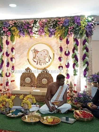 A candid shot of a pooja being performed in front of our cow-themed backdrop. The setup provides a beautiful and meaningful background for capturing memories of your special rituals.