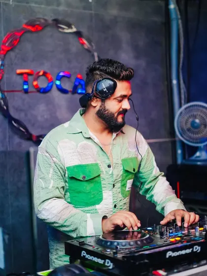 In the zone at Toca, with a slight smile. Mixing beats and creating vibes is my passion.