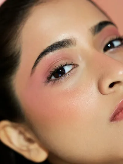 A close-up on the eye and cheek, showing how the "glass skin" technique makes the entire face look vibrant and healthy.