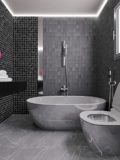 A bold bathroom design in shades of grey and black, featuring mosaic tiles, a freestanding bathtub, and modern fixtures for a dramatic look.
