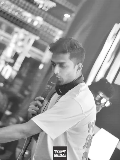Let's go. A focused, black and white shot of me on the mic at Sugar Factory Reloaded, ready to take the energy to the next level.
