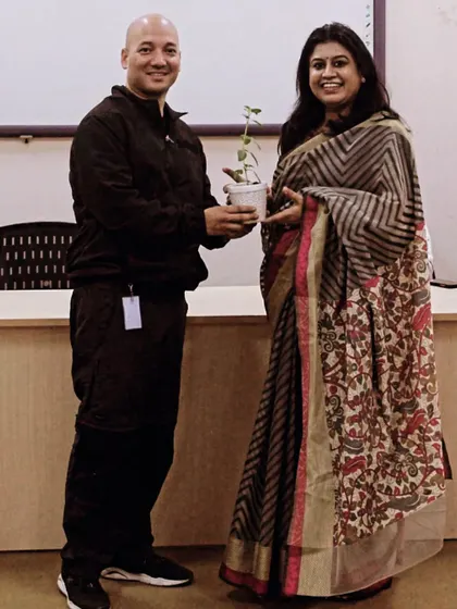 Receiving a sapling as a token of appreciation. This is a fitting symbol for what we do at Kavach: we plant a seed of confidence and strength that grows into a protective tree.