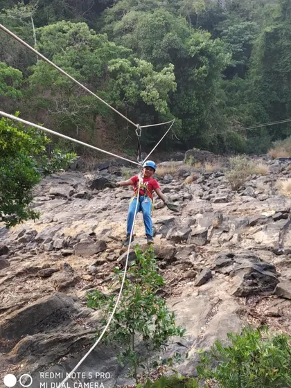 A participant navigates a rope bridge, one of the many adventure activities we offer.