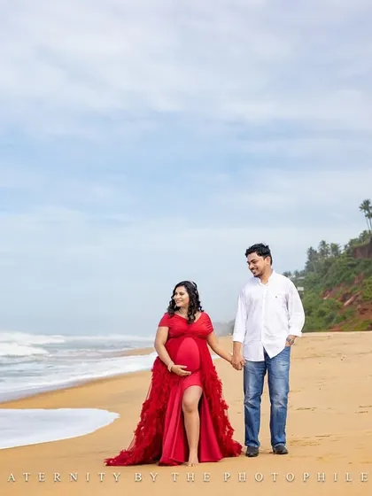 A classic walking shot on the beautiful Varkala beach, showcasing the couple's connection and the stunning natural scenery.