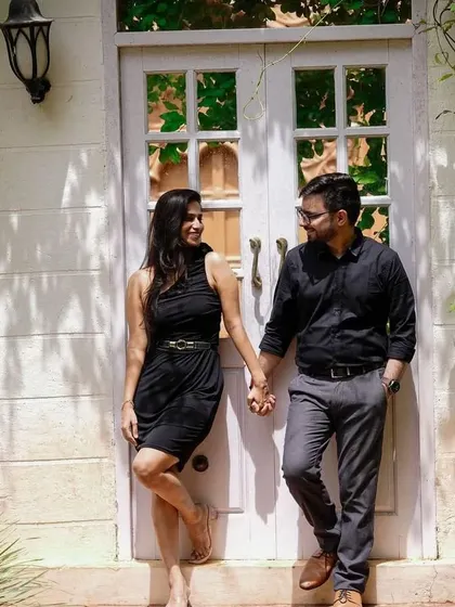 A more casual and intimate moment from the same pre-wedding shoot. The couple is coordinated in simple black outfits, showing the versatility of our rental collection.