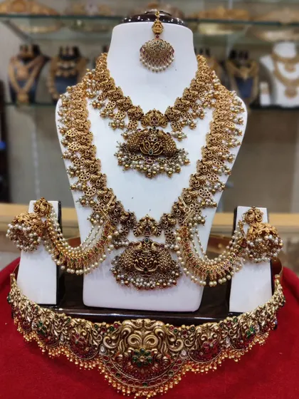 A complete antique-finish bridal set with matching ear chains, perfect for supporting heavy jhumkas and completing the look.