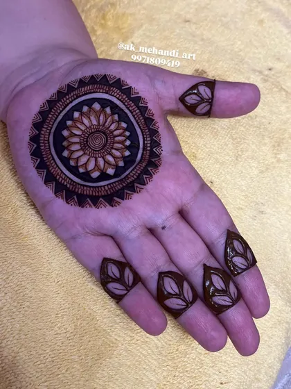 A bold mandala design for Karwachauth. The dark filling around the central flower makes the pattern stand out beautifully.