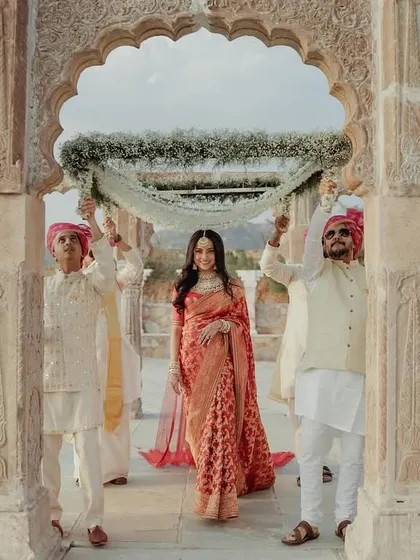 A stunning shot of the bride's entry through a beautiful stone archway at a destination wedding.
