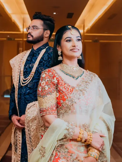 A stylish, modern portrait of the couple, with the groom standing behind the bride, creating a sense of protection and partnership.