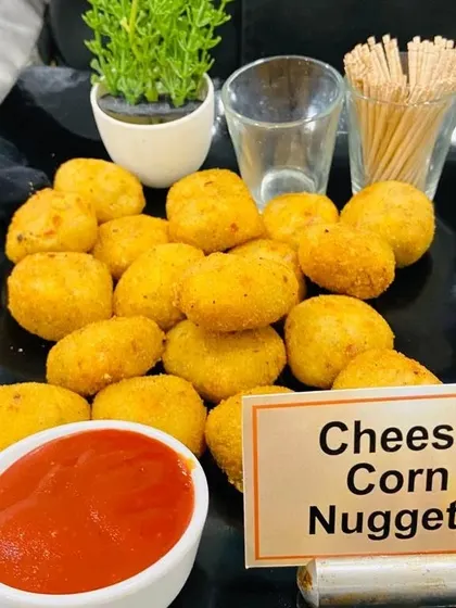 Crispy Cheese Corn Nuggets served with ketchup. This classic comfort food is always a hit at office parties and casual corporate events.