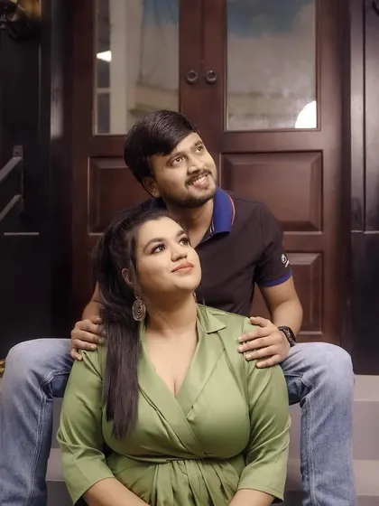 A classic pre-wedding pose on a set of stairs, capturing a moment of shared dreams and looking towards the future together.