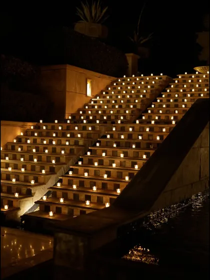 The grand staircase, illuminated by hundreds of candles, creating a breathtaking and dramatic pathway for the all-white Sufi night.