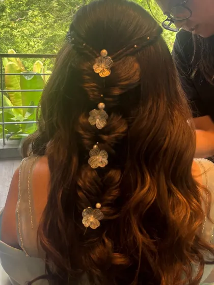 A close-up of the back of the engagement hairstyle, highlighting the unique twisted sections and the pretty floral clips.