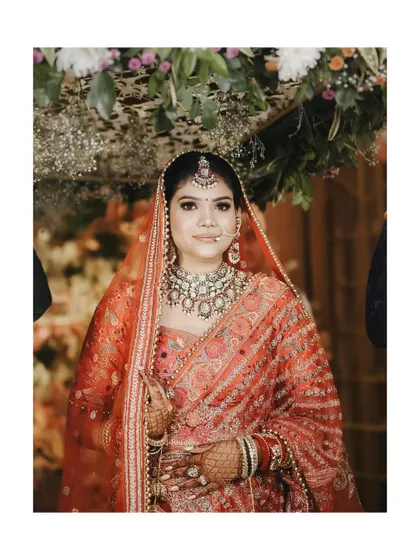 A simple, elegant, and direct bridal portrait, capturing her beauty against a backdrop of flowers.