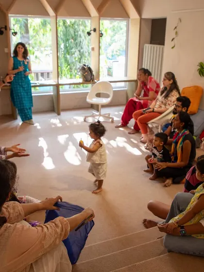 A storytelling session in progress during our Holi event. We gather the children and parents in a circle to share stories, songs, and laughter, making everyone feel part of the community.