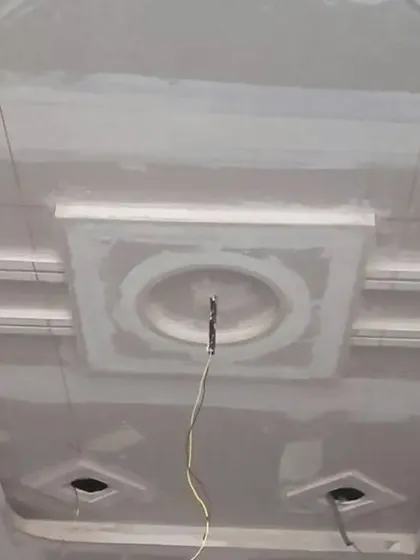 A classic tray ceiling design with a central circular medallion, shown in its raw POP state.