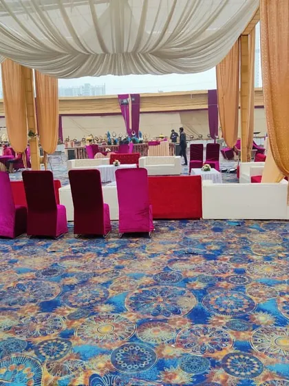 This image shows the arrangement of both lounge and standard seating across a large, carpeted event space.