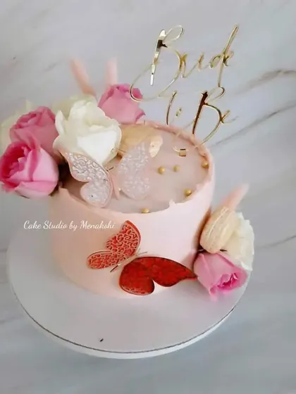 A pretty floral cake for a bride-to-be. This design uses fresh roses and delicate butterflies to create a romantic and celebratory feel, all without fondant.