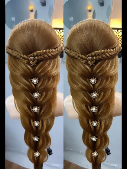 A stunningly intricate braid look, decorated with beautiful floral pins. This style combines multiple braiding techniques.