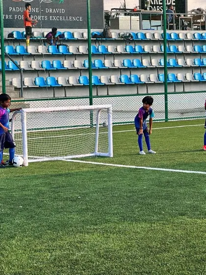 Players setting up for a free-kick drill, practicing their set-piece skills.