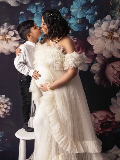 A tender kiss between mother and son during her maternity session. These are the unscripted, in-between moments that hold so much love and meaning.