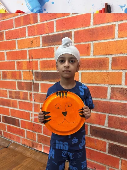 Another happy student displays his tiger craft. We love seeing the unique personality each child brings to their artwork.