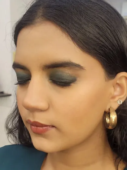 Another angle of the formal makeup look, with eyes closed to show the full effect of the deep green smokey eyeshadow.