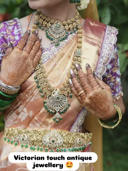 A close-up of a bride wearing my Victorian-touch antique jewellery. The set includes a choker and a matching long necklace, both adorned with green stones, perfect for a royal reception look.