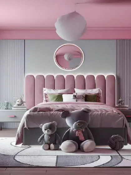 A soft and dreamy pink bedroom with a plush upholstered headboard and plenty of teddy bears for a cozy feel.