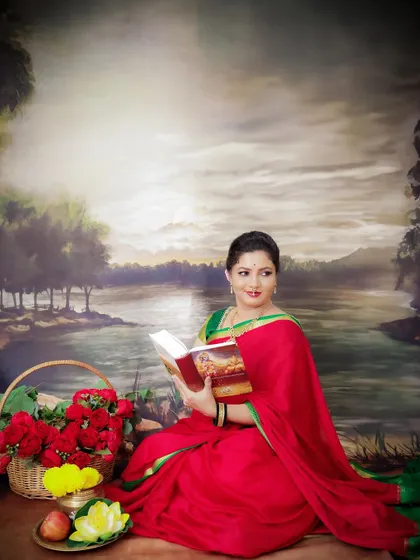 A quiet and contemplative portrait in traditional attire. The mom-to-be is reading, surrounded by props that evoke a sense of peace and heritage.