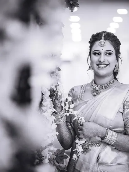 A beautiful black and white candid of the bride, capturing a moment of quiet happiness.