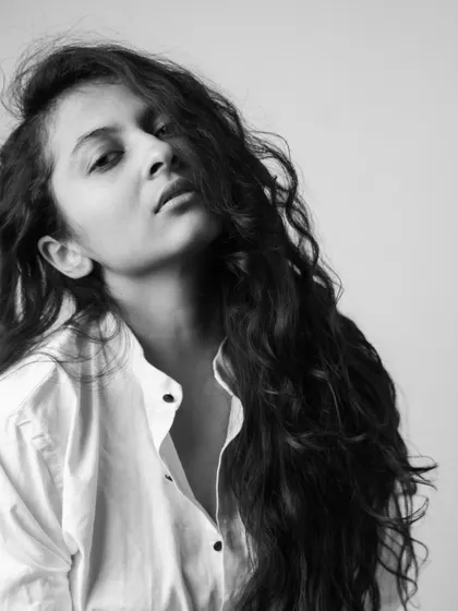 A simple portrait in a white shirt, with my hair falling naturally. This shot from the 'Dans Mon Boudoir' series is about capturing an unfiltered and relaxed moment.