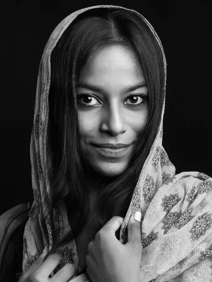 This black and white portrait uses a dupatta to frame the model's face, drawing attention to her expressive eyes. It's a beautiful example of a classic portrait with an ethnic touch, suitable for a variety of modeling work.