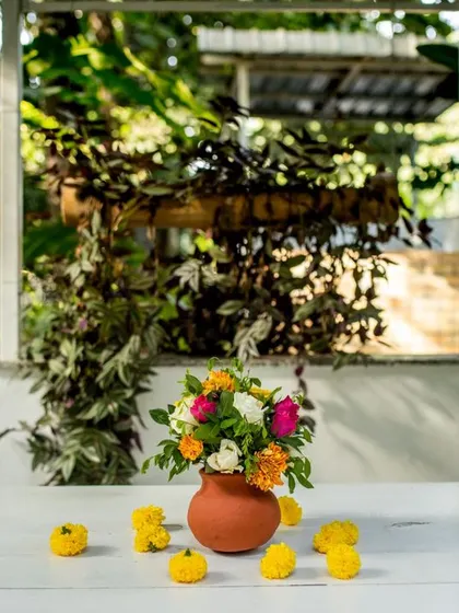 A simple yet beautiful detail. A small pot of colorful flowers on a white table, adding a touch of freshness to the decor.