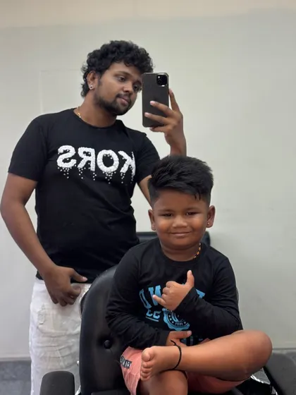 Arya giving a shaka sign, happy with his new cut.