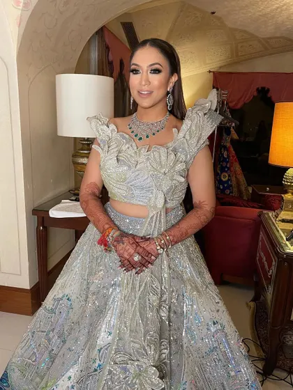 A perfect glam look for a sangeet or reception, with the hair styled away from the face to show off the statement jewelry.