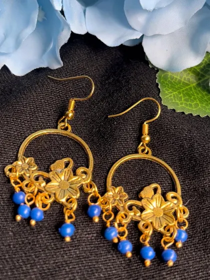 These charming gold-tone hoop earrings are decorated with floral motifs and blue beads. A cute and budget-friendly option for everyday style.
