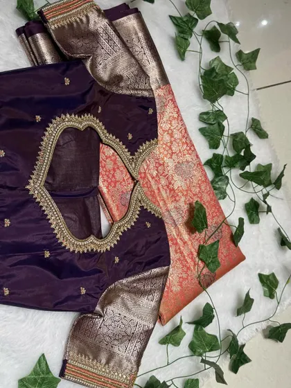 Dripping in drama and dipped in tradition. This wine and orange saree is a riot of regal threads and retro embroidery.