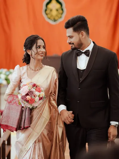The happy couple walks down the aisle together after their Christian wedding ceremony, their faces beaming with joy.